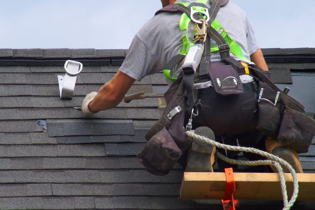 man wearing safety gear on roof