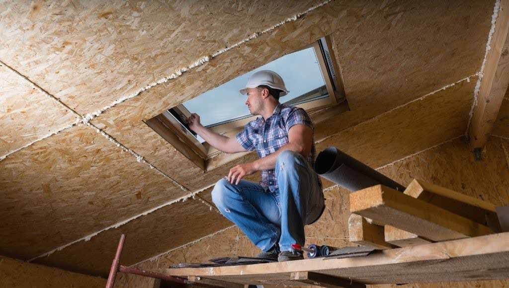Man inspecting a skylight on a newly constructed home.